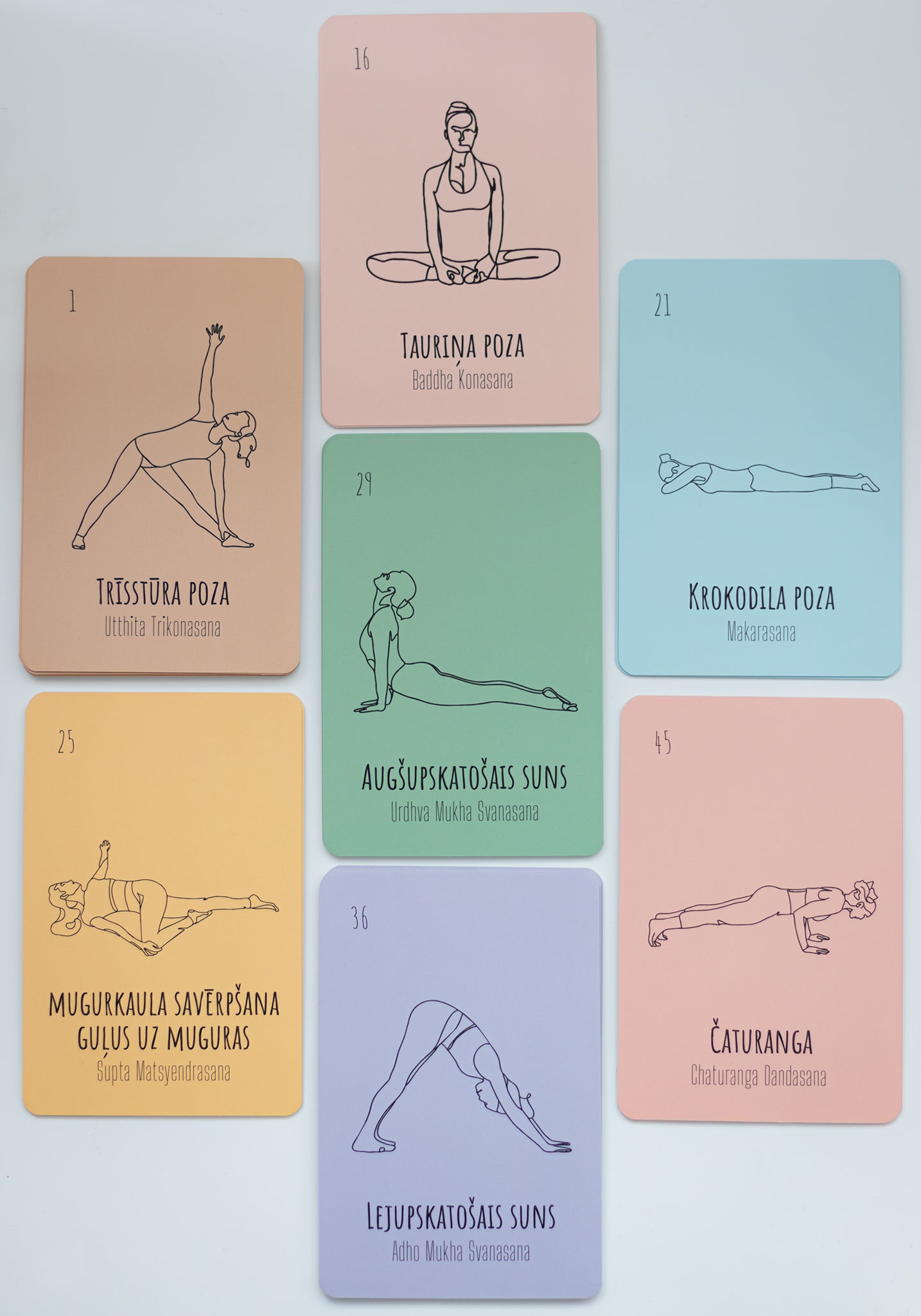 A set of yoga pose cards arranged on a light gray background. The cards are peach, pink, green, yellow, and lavender, each featuring a black line drawing of a yoga pose and Latvian text.